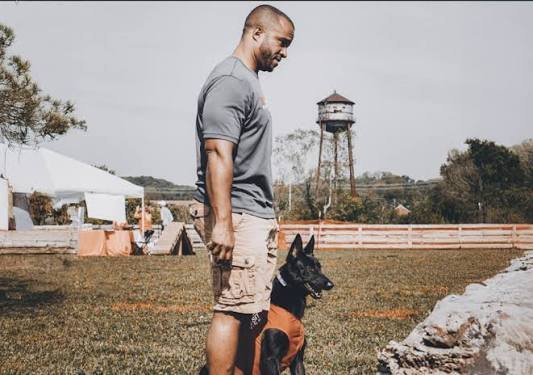 Teddy Wall, owner of Talking Tails Dog Training, working with a Belgian Malinois